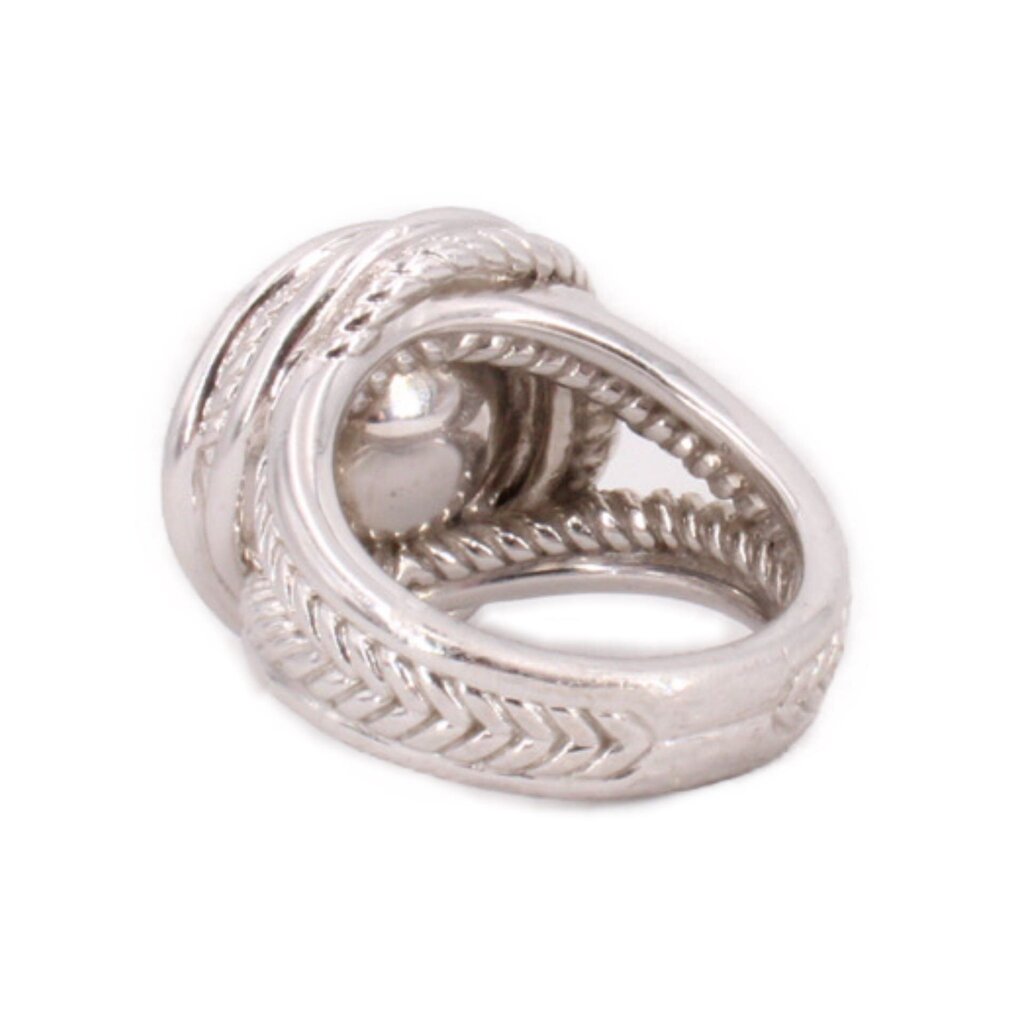 Sterling silver crossover ring with textured band and visible pearl setting underside