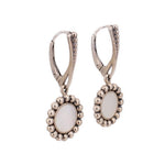 Silver-tone hinged drop earrings with round mother-of-pearl disc and beaded halo setting