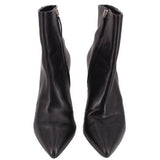 Pair of black ankle booties with pointed toe and side zipper