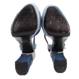 Denim patchwork heeled sandal view of underside with black soles and heel caps