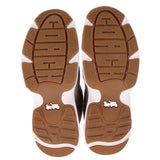 Brown tread sneaker outsoles with white rubber panels, two bottom views