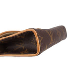 Close-up of monogram belt bag opening with tan leather trim