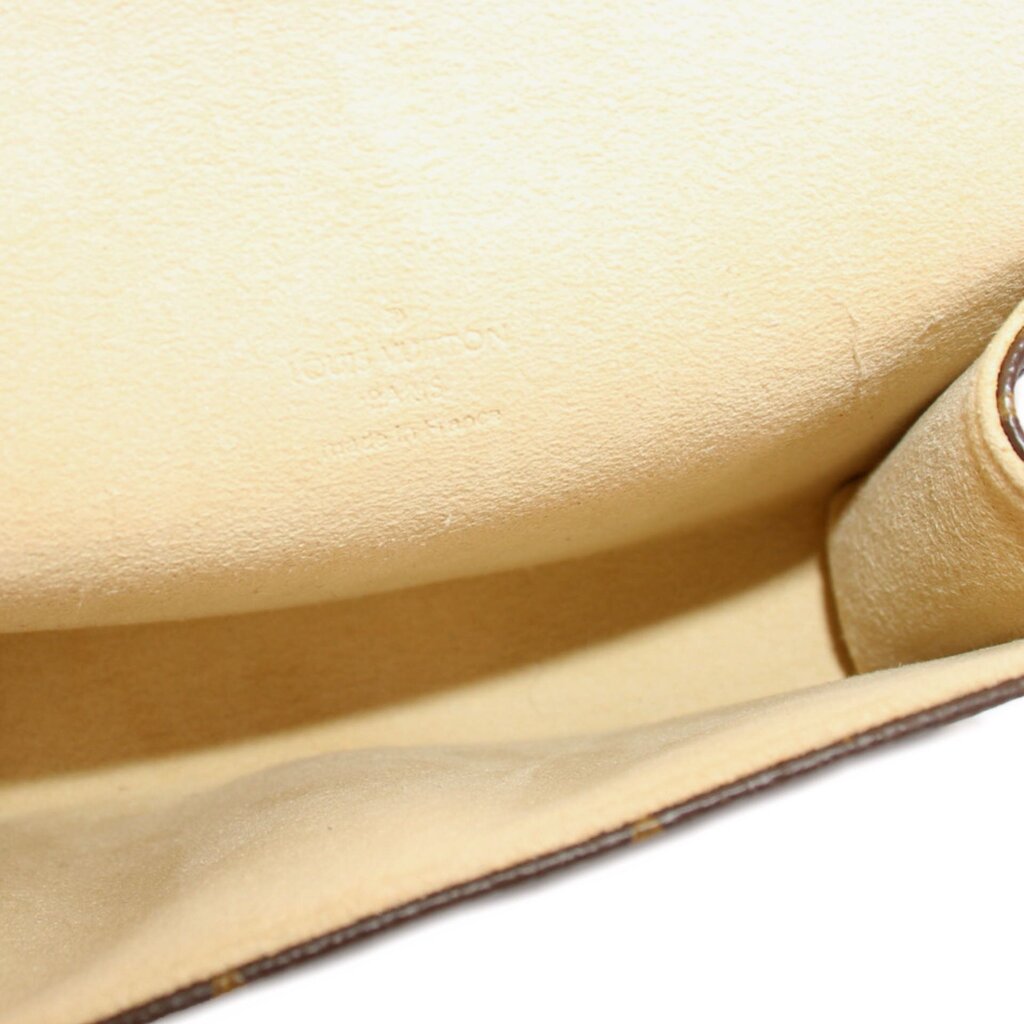 Beige leather-lined interior of a Louis Vuitton monogram belt bag
