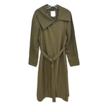 Green trench coat with wide collar and self-tie belt, front view.