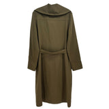 Green trench coat back view with wide collar and self-tie belt.