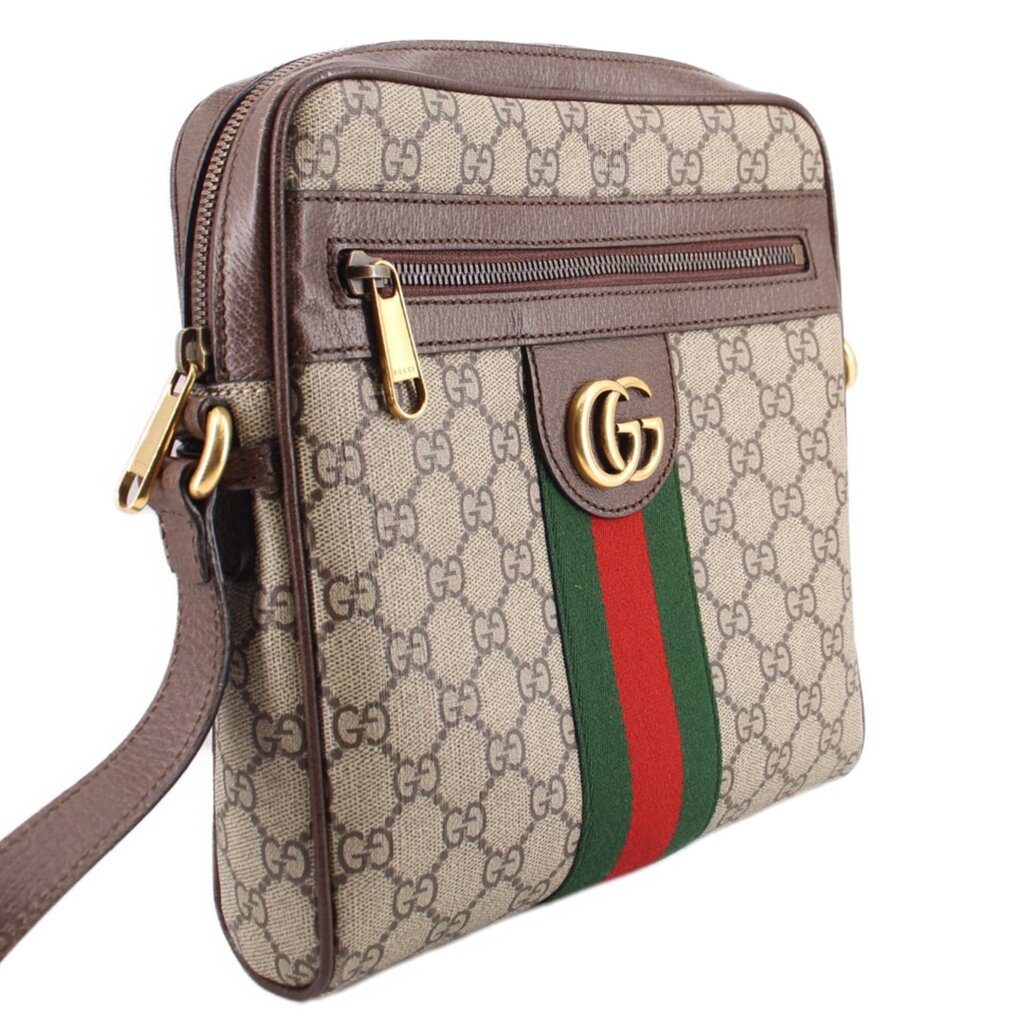 GUCCI crossbody messenger bag side view with GG canvas, brown leather edges, and web stripe