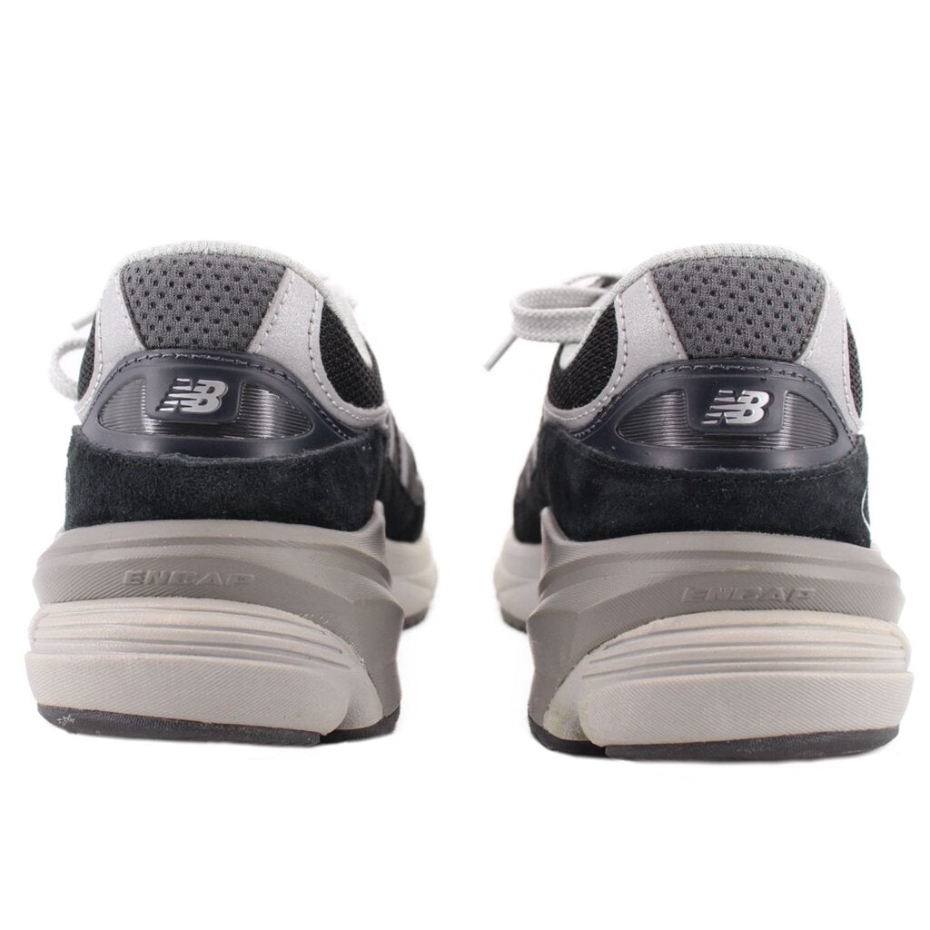 Pair of New Balance sneakers viewed from the heel, showing padded collars and layered soles