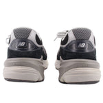 Pair of New Balance sneakers viewed from the heel, showing padded collars and layered soles