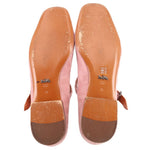 Pink suede flat soles and insoles, showing wear marks and size stamp