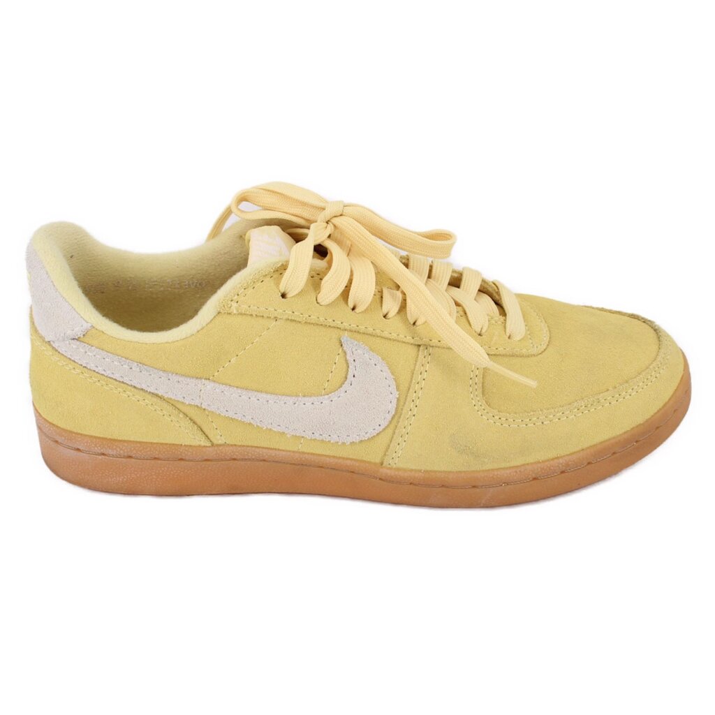 Yellow suede Nike sneakers, side view with white swoosh and gum rubber sole