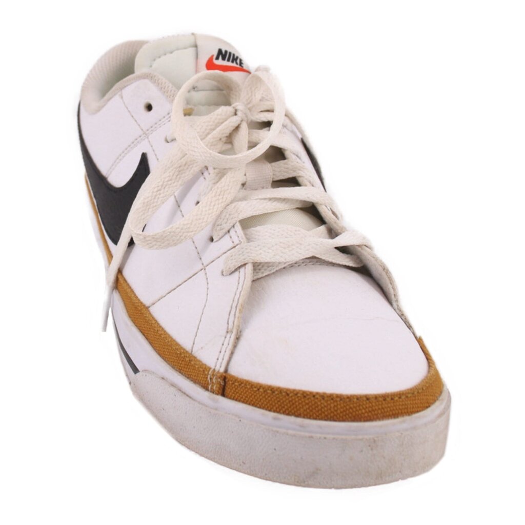 White leather Nike sneaker with tan trim, black Swoosh, and lace-up front