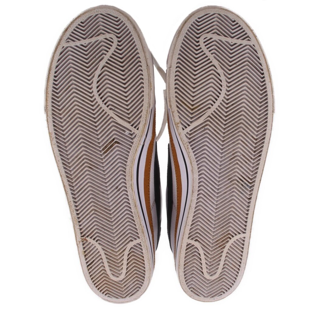 Pair of Nike sneakers showing textured herringbone rubber outsoles
