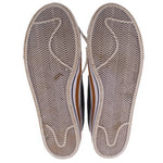 Pair of Nike sneakers showing textured herringbone rubber outsoles