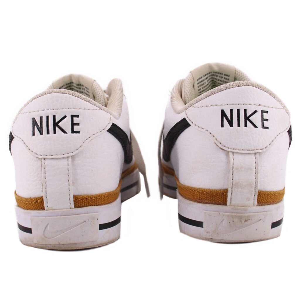 Pair of white Nike leather sneakers showing branded heels and tan midsole stripes
