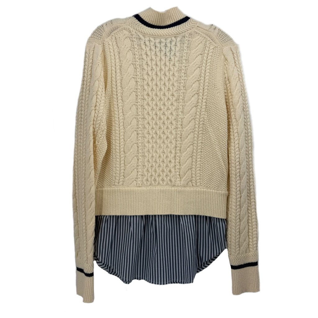 Cream cable-knit sweater with navy striped layered bottom and ribbed cuffs
