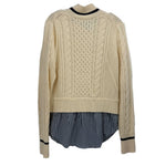 Cream cable-knit sweater with navy striped layered bottom and ribbed cuffs