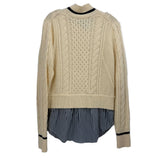 Cream cable-knit sweater with navy striped layered bottom and ribbed cuffs