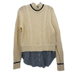 Cream cable-knit sweater with navy striped peplum hem and ribbed crew neckline