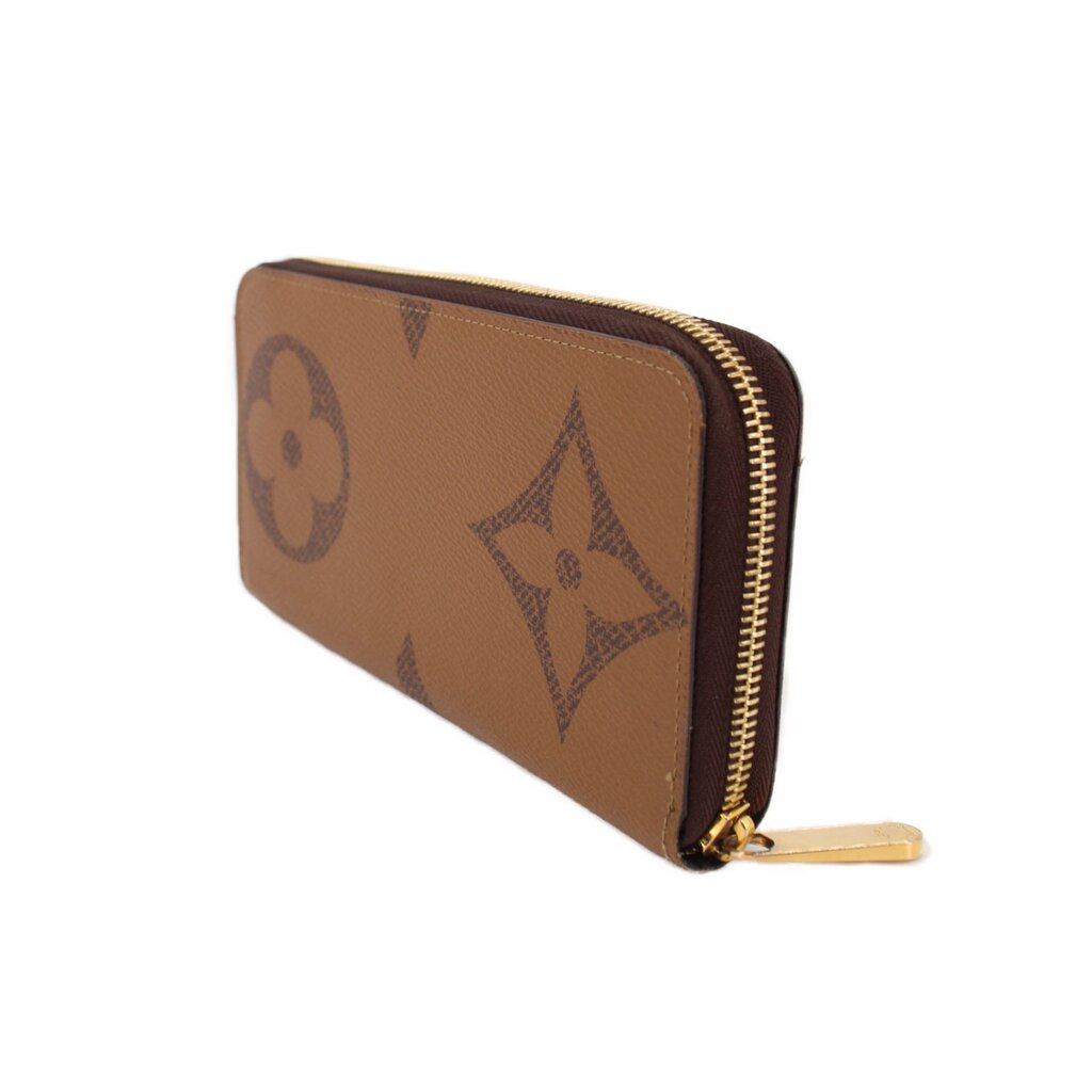 Brown monogram zip wallet with gold zipper along the edge, side angle