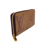 Monogram zip wallet viewed from side, brown with gold-tone zipper