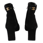 Black suede ankle booties with gold buckle strap detail and block heel