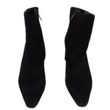 Pair of black suede ankle booties with side profile and pull-on opening