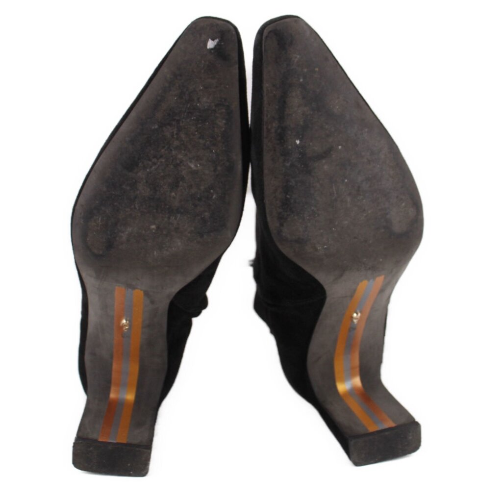 Suede bootie heel underside with orange and gold stripe accents