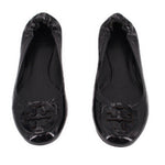 Pair of black patent ballet flats with bow-like collar and logo embossed toe
