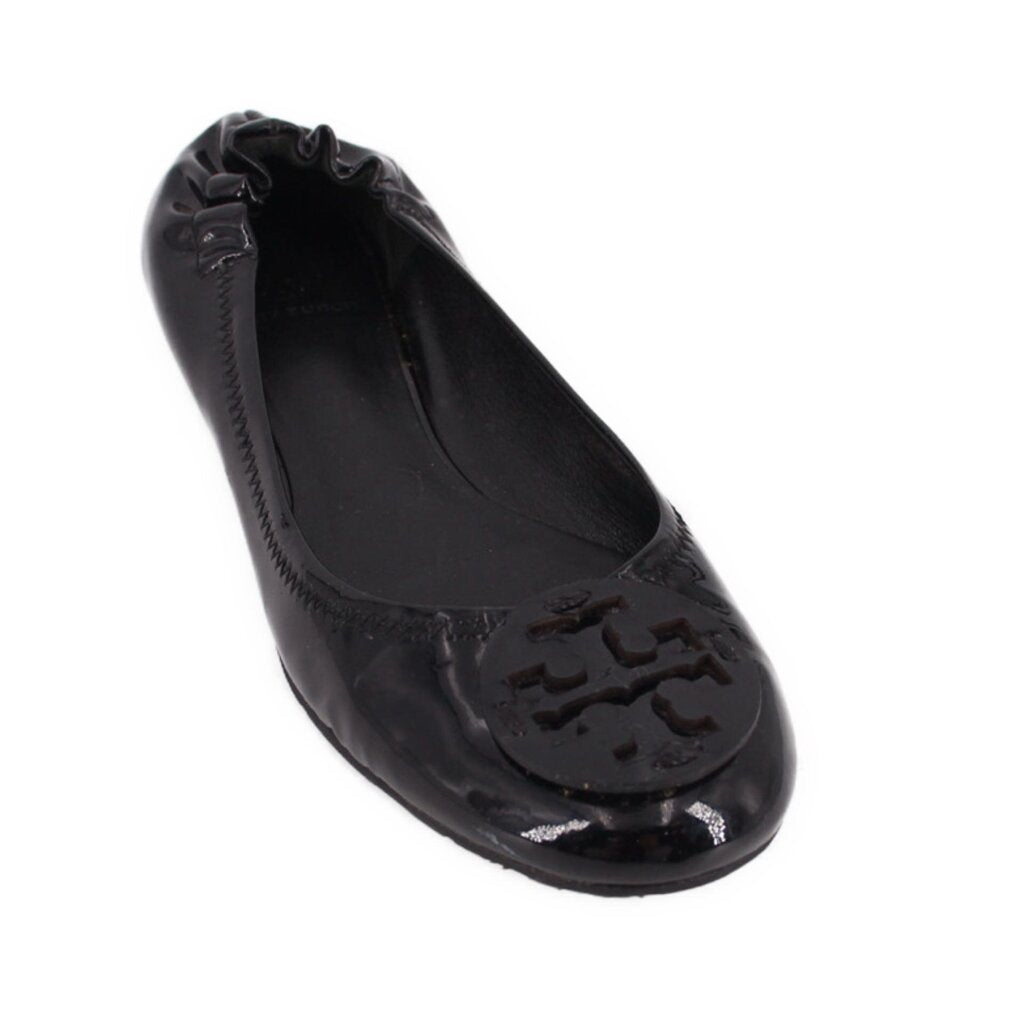 Black patent ballet flat with raised logo detail at toe and scalloped apron