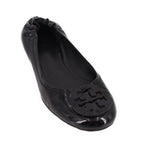 Black patent ballet flat with raised logo detail at toe and scalloped apron