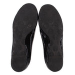 Patent flat outsoles with repeating logo pattern on dark rubber soles