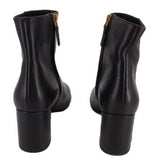 Black leather ankle boot pair, back view of short heel and side zipper.