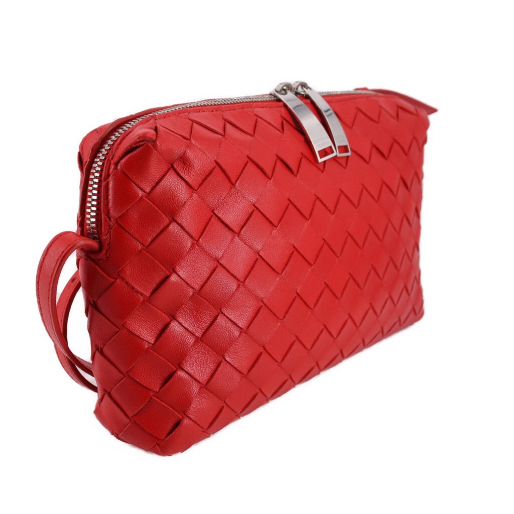 Red woven leather crossbody bag with top zip, braided strap, and side front view