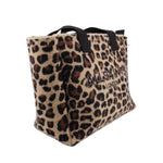 Leopard-print tote shown from the side, with black handles and a wide base