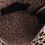 Inside of the leopard-print tote with dark patterned lining and black strap