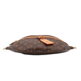 LOUIS VUITTON monogram belt bag with top zipper and leather luggage tag, side ties.