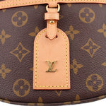 LOUIS VUITTON monogram belt bag leather tag with LV emblem, tied to front loop.