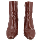 Pair of brown ankle boots with side zipper and rounded toe