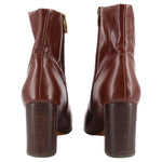 Brown ankle boots with side zippers and stacked block heel, back view