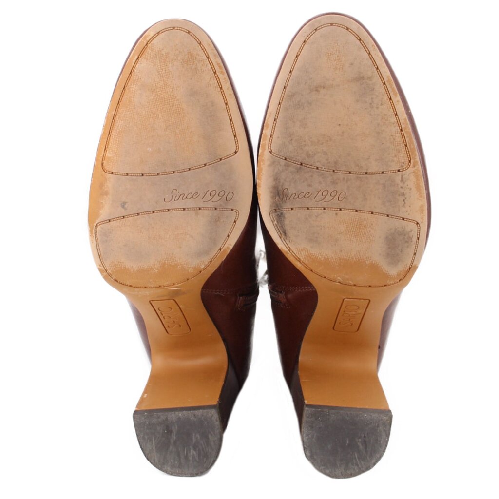 Brown boot outsoles with 'Since 1990' printed on footbeds