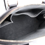 Black bag interior with gray fabric lining and open zipper at the top edge.