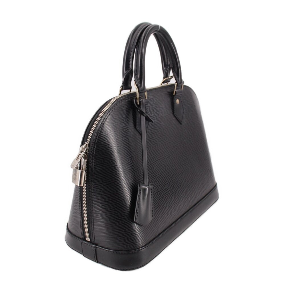 Black structured leather top-handle bag, side view with silver zipper hardware detail.