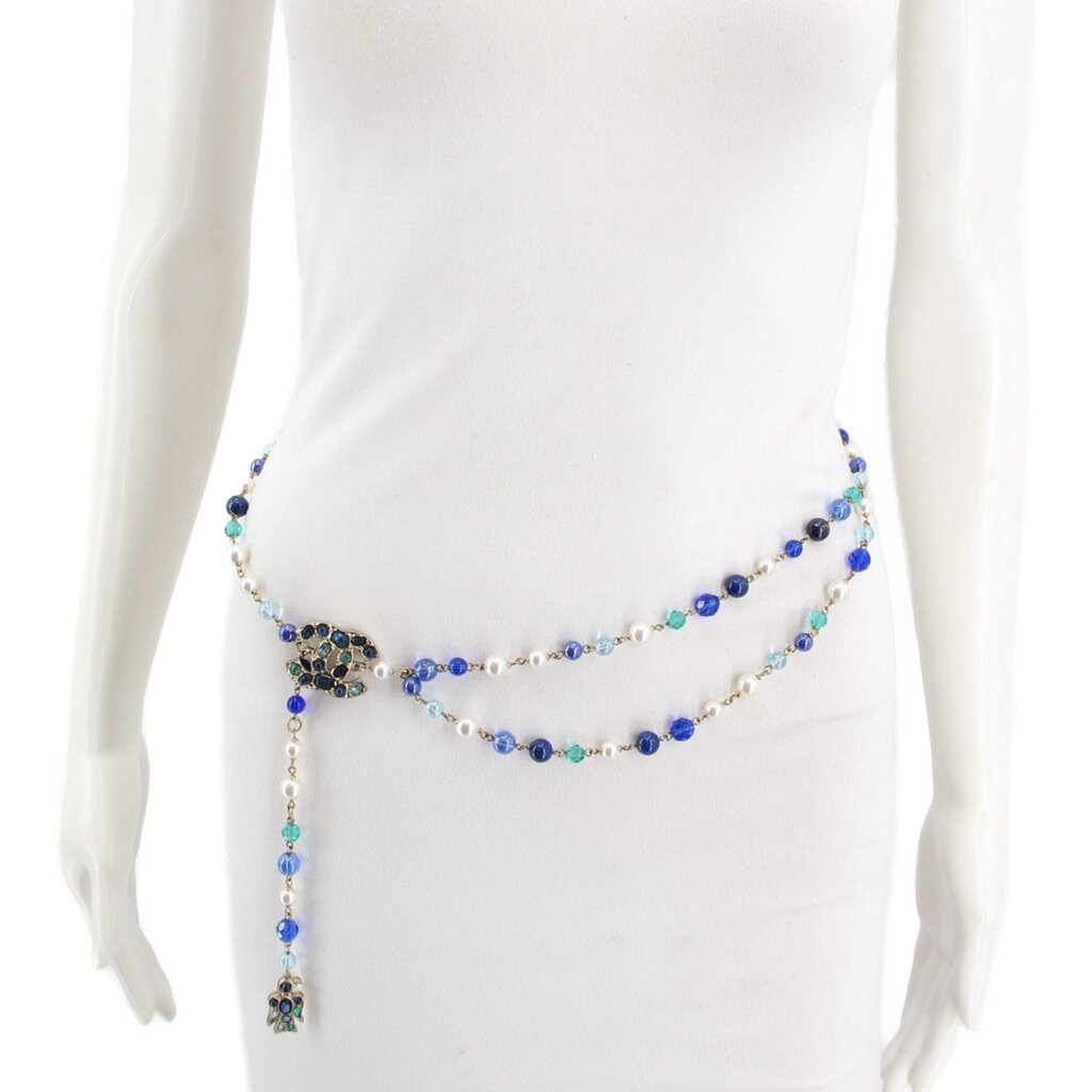 Long beaded belt worn at the waist, with a jeweled side accent and hanging end