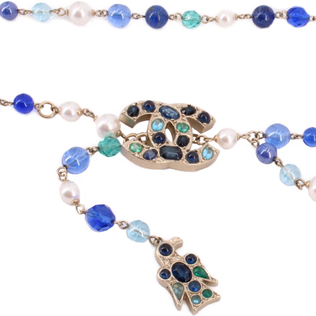Close-up of beaded belt with blue and turquoise beads and ornate jeweled accents