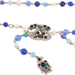 Close-up of beaded belt with blue and turquoise beads and ornate jeweled accents