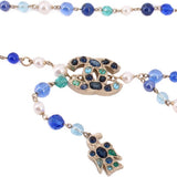 Close-up of beaded belt with blue and turquoise beads and ornate jeweled accents