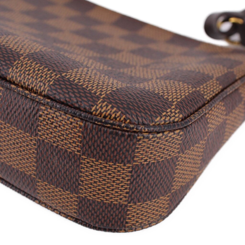 Louis Vuitton Damier Ebene corner detail with dark check pattern and rounded trim