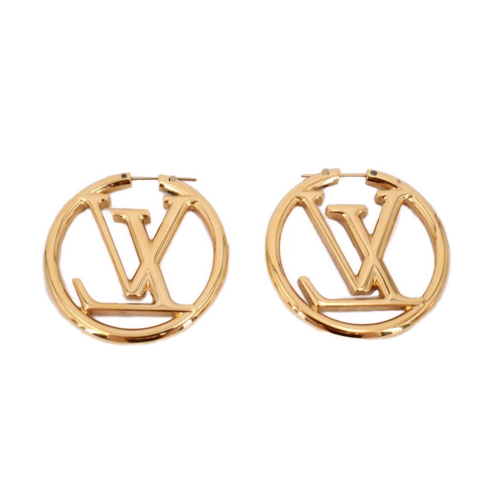 Gold LOUIS VUITTON hoop earrings featuring LV monogram and smooth clasp detail.