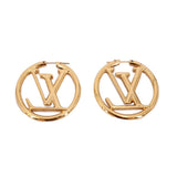 Gold LOUIS VUITTON hoop earrings featuring LV monogram and smooth clasp detail.