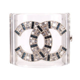 CHANEL clear cuff bracelet with interlocking logo and blue, black, and clear jeweled accents